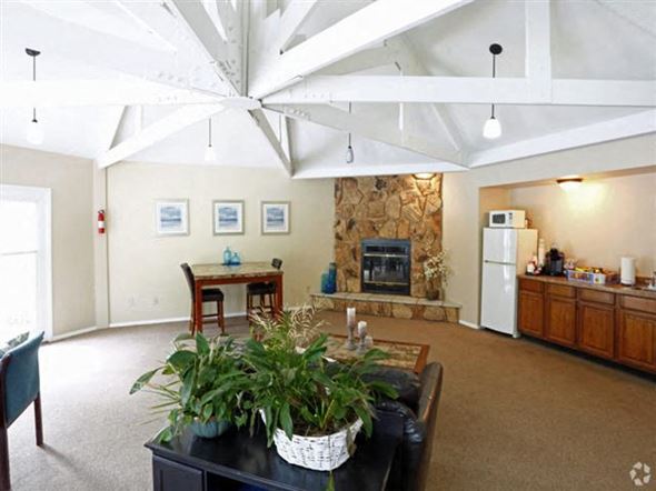 Monroe townhouse for rent - a living room with a table and a fireplace