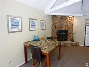 Monroe townhouse for rent - a dining room with a table and a stone fireplace