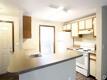 Toledo townhouse for rent - a kitchen with white appliances and a counter top