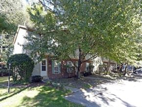 Toledo townhouse for rent - a house with a tree in the front of it