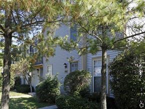 Toledo townhouse for rent - a blue house with trees in front of it