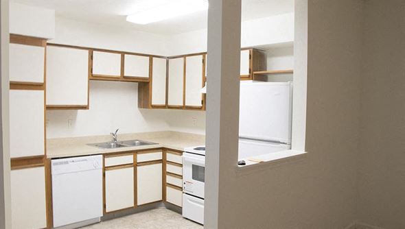 Deerfield Beach apartment for rent - an empty kitchen with white appliances and wooden cabinets