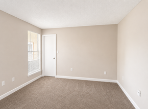 Deerfield Beach apartment for rent - A room with a carpeted floor and a white door.