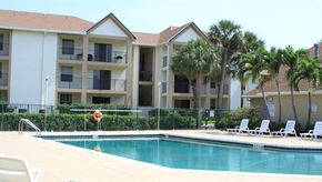 Deerfield Beach apartment for rent - a swimming pool in front of an apartment building