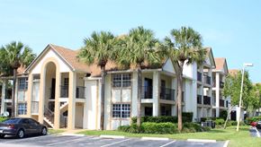 Deerfield Beach apartment for rent - a building with palm trees in front of it