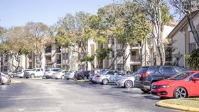 Deerfield Beach apartment for rent - a parking lot filled with cars in front of apartments