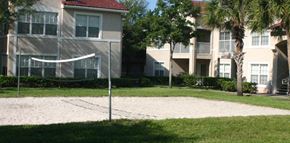 Greenacres apartment for rent - a volleyball court in front of an apartment building