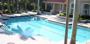 Greenacres apartment for rent - a large swimming pool in front of a house