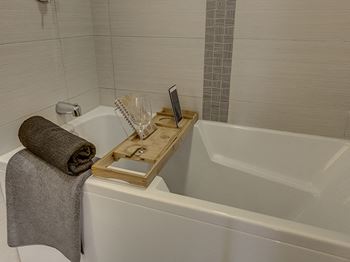 Deep soaking tub with armrests