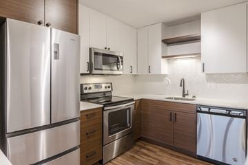 Chicago apartment for rent - a kitchen with stainless steel appliances and white cabinets