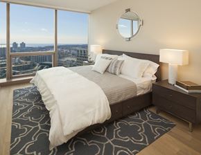 Stamford apartment for rent - a bedroom with a bed and a view of the city