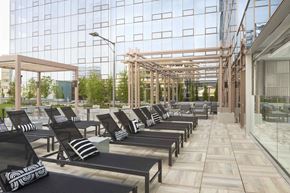 Stamford apartment for rent - a lounge area with chairs and tables in front of a glass building