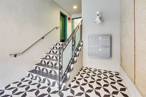 San Francisco apartment for rent - A staircase with a metal railing and a tiled floor.