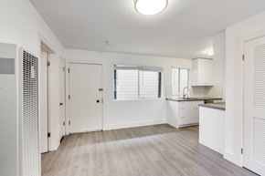 San Francisco apartment for rent - A white room with a window and a kitchen area.