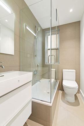 Manhattan apartment for rent - a bathroom with a shower toilet and sink