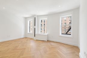 Manhattan apartment for rent - a living room with a hardwood floor and three windows