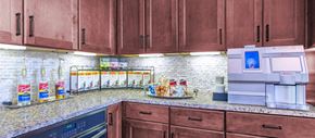 Richmond apartment for rent - a kitchen with wood cabinets and a counter top and a sink
