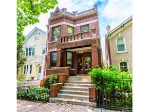 Chicago apartment for rent - the front of a brick house with stairs and a gate