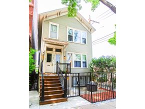 Chicago apartment for rent - A house with a grey siding and a brown door.