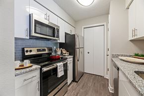 Pikesville apartment for rent - a kitchen with stainless steel appliances and white cabinets