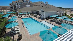 Sewell apartment for rent - an aerial view of a swimming pool with umbrellas and a resort style pool