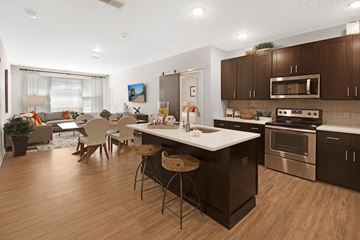 Sewell apartment for rent - an open kitchen and living room with a dining room table and chairs