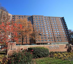 Washington apartment for rent - a large building with a sign in front of it