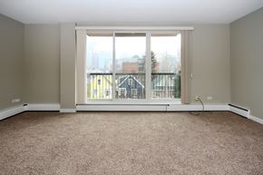 Calgary apartment for rent - an empty living room with a large window