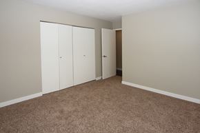Calgary apartment for rent - an empty room with carpet and white closet doors