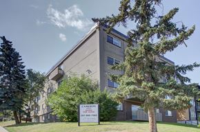 Calgary apartment for rent - a large apartment building with a sign in front of it