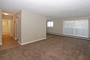 Calgary apartment for rent - the living room and dining room of an apartment with a large window