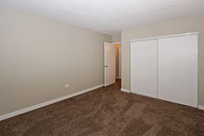 Calgary apartment for rent - an empty room with carpet and a door to a closet