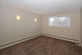 Calgary apartment for rent - an empty room with carpet and a window