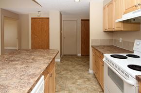Calgary apartment for rent - a kitchen with white appliances and granite counter tops