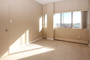 Calgary apartment for rent - the living room of an empty apartment with large windows