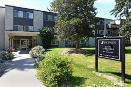 Edmonton apartment for rent - The image shows a building with a sign in front that reads "BREWMAN".