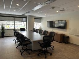 Edmonton apartment for rent - A conference room with a long table and chairs.