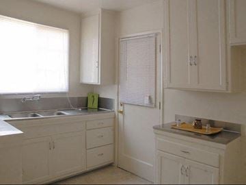 Los Angeles apartment for rent - A kitchen with white cabinets and a sink.