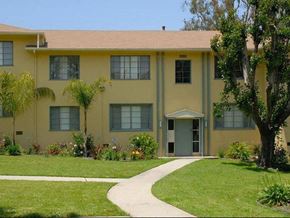 Los Angeles apartment for rent - A yellow building with a white door and windows.
