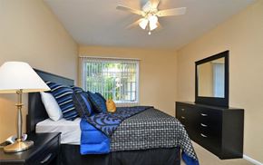Los Angeles apartment for rent - A bedroom with a bed, dresser, mirror, and a ceiling fan.