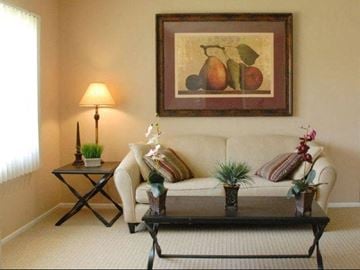 Los Angeles apartment for rent - A living room with a couch, coffee table, and a painting of fruit.