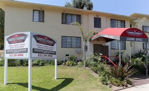 Los Angeles apartment for rent - A building with a sign that says "Santos ToTas" and a phone number.