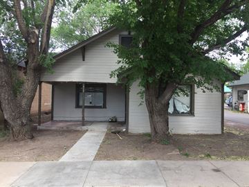 Flagstaff house for rent - a white house with trees in front of it