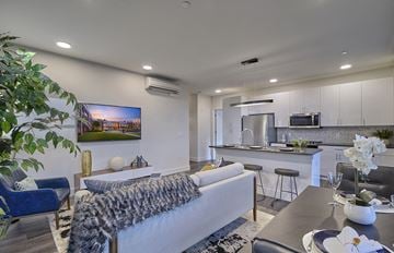Union apartment for rent - A modern living room with a grey couch and a large painting on the wall.