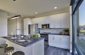 Union apartment for rent - A modern kitchen with white cabinets and a large island.