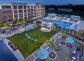 Union apartment for rent - A large building with a pool and a patio area.