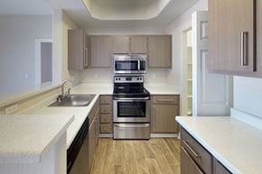 Phoenix apartment for rent - Kitchen with stainless steel microwave above matching oven, modern fixtures on cabinet fronts