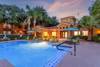 Sparkling pool & spa with poolside loungers & umbrellas