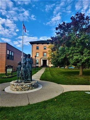 Canandaigua apartment for rent - a statue in front of a building with a flag