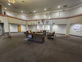 Rochester apartment for rent - A large room with a carpeted floor and a balcony on the second floor.